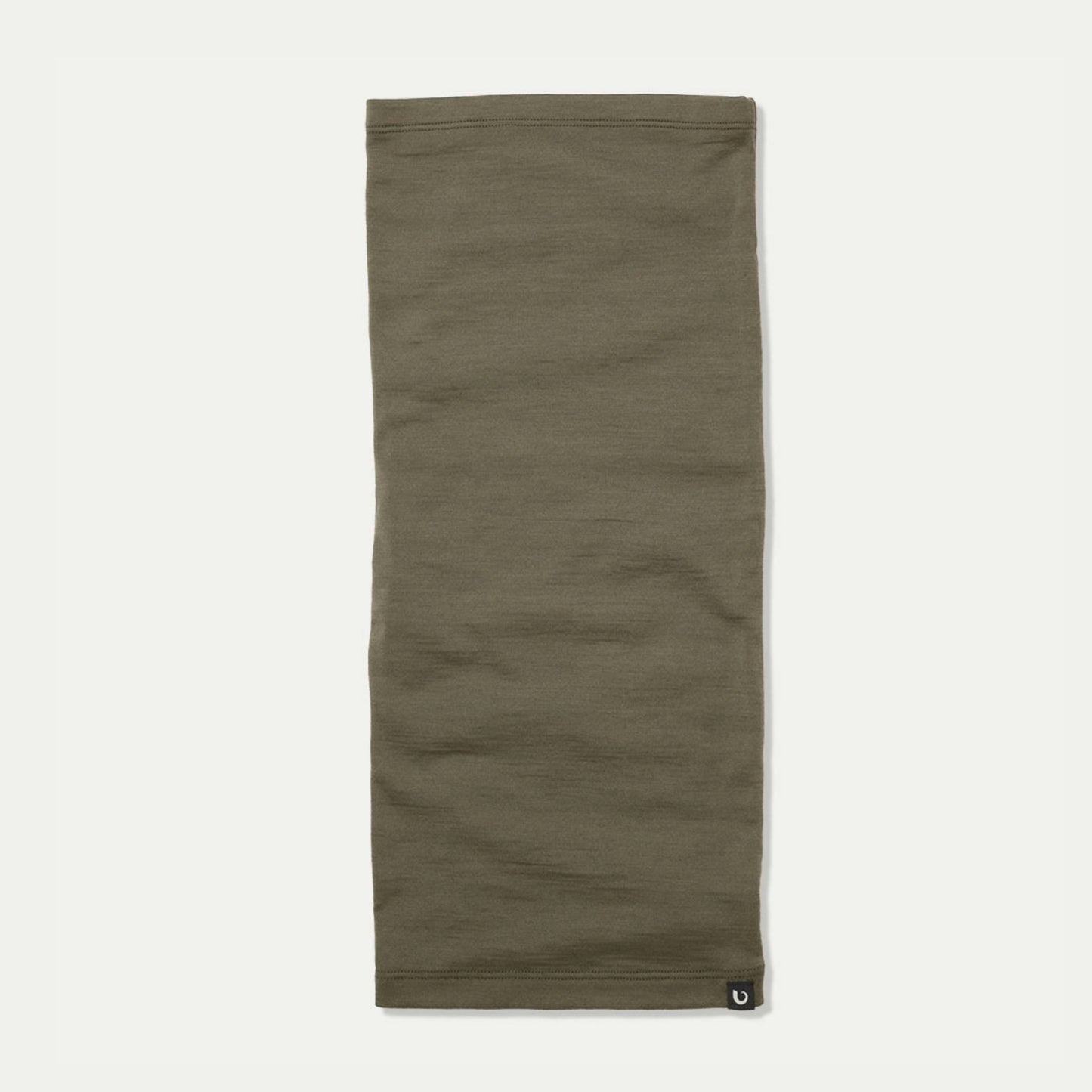 An light sage green Merino neck gaiter laid flat against a light off-white background, featuring a small black Bluey Merino logo patch on the bottom right hem. © Bluey Merino Tasmania