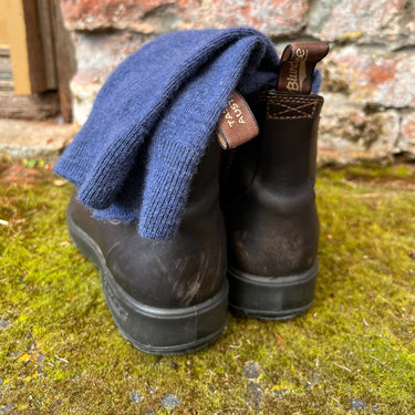 Pair of Blunstone boots with blue Alpaca and wool blend socks on a mossy ground © Bluey Merino Tasmania