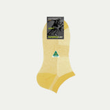 Yellow sock with a brand label on a light gray background