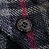 Close-up of a textured fabric with a button labeled 'Bluey Merino Tasmania'. Stanley Overshirt. Made in Tasmania.