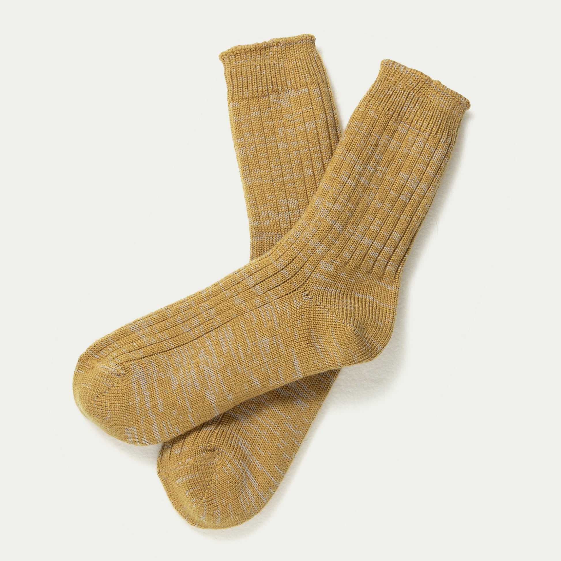 A pair of mustard yellow ribbed crew Australian Merino socks with a subtle light grey marle-marl pattern, displayed on a clean off-white background. © Bluey Merino Tasmania
