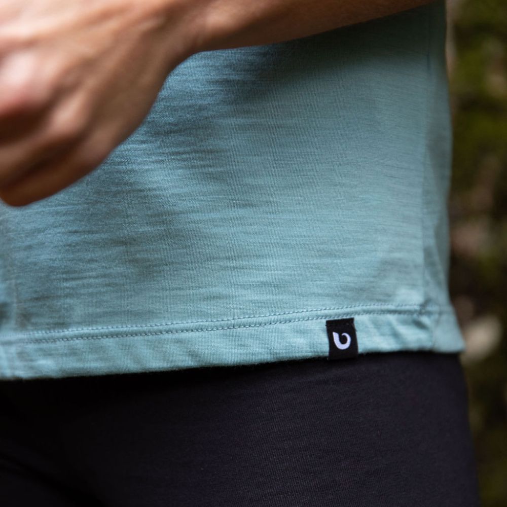 Close up © Bluey Merino Tasmania tag on a duck egg blue (Oyster Bay) Merino cropped t-shirt