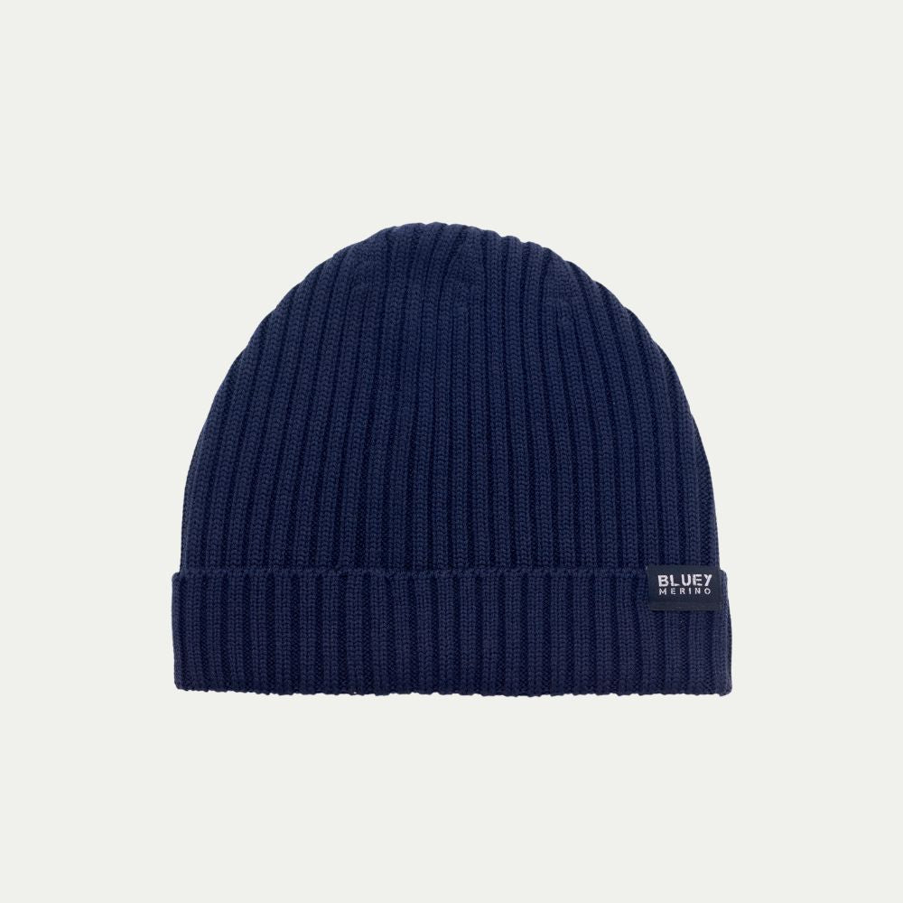 Fisherman knit Navy blue Merino beanie with a brand logo on a light grey background © Bluey merino Tasmania