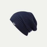 Fisherman knit Navy blue Merino beanie with a brand logo on a light grey background - Slouchy style © Bluey merino Tasmania