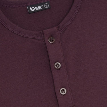 Maroon long-sleeve henley shirt on a light grey background © Bluey Merino Tasmania