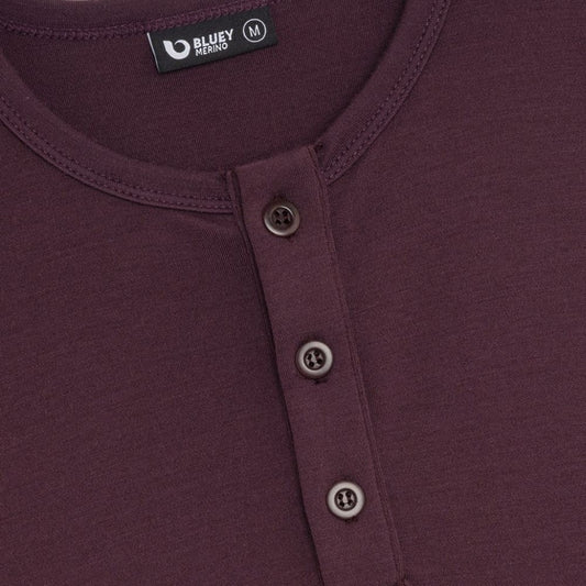Maroon long-sleeve henley shirt on a light grey background © Bluey Merino Tasmania