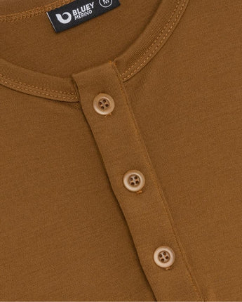Close-up of a brown shirt with buttons and a Bluey Merino label.