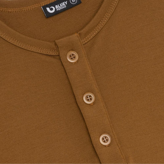 Close-up of a brown shirt with buttons and a Bluey Merino label.