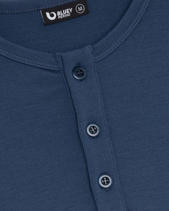 Close-up of a blue shirt with button details and Bluey Merino label.