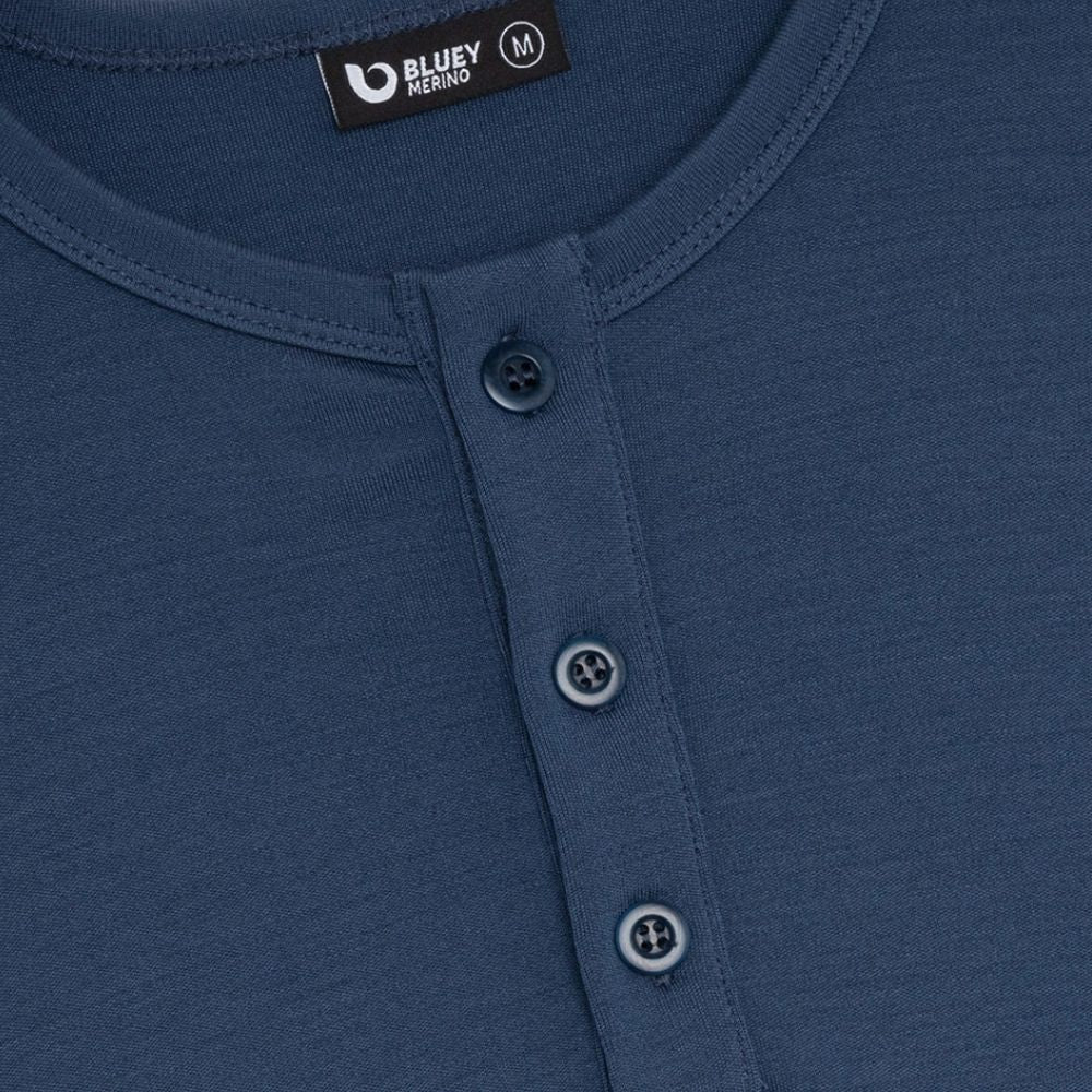 Close-up of a blue shirt with button details and Bluey Merino label.
