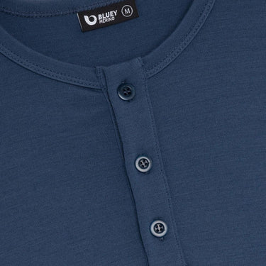 Close-up of a blue shirt with button details and Bluey Merino label.