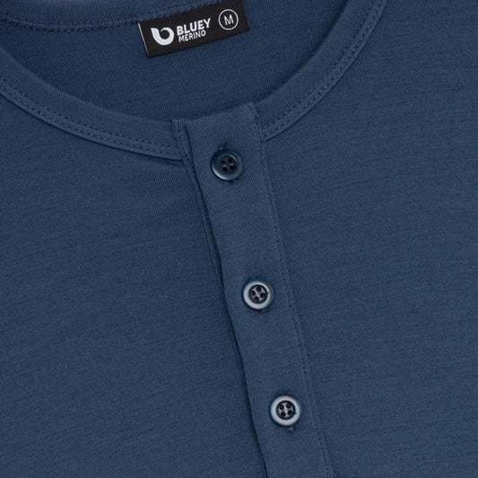 Close-up of a blue shirt with button details and Bluey Merino label.
