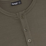 Close-up of a sage green shirt with button details and Bluey Merino label.