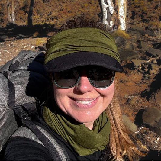 Julia is wearing Bluey Merino's short neck warmer around her head to protect her ears from the wind and keep her hat in place. She is also wearing the long Merino neck warmer around her neck © Julia Patten