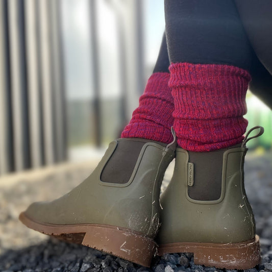closeup on feet wearing Merry people boots, pink and red thick Merino boot socks © Bluey Merino Tasmania