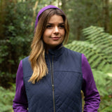 Woman wearing a purple Merino hoodie  and Navy Merino gilet vest standing in a forest in the Blue Mountains, NSW, Australia © Bluey Merino Tasmania