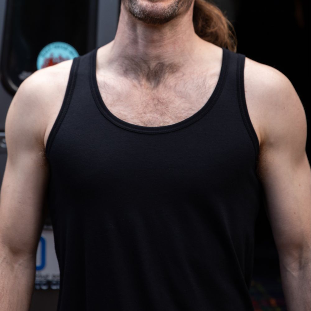 Person wearing a black Merino tank top with a blurred background © Bluey Merino Tasmania